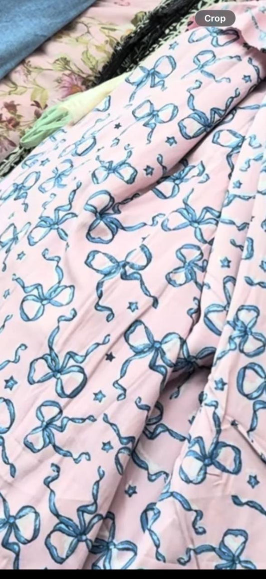 Buy Cotton Poplin Pink Base Bow Printed Fabric